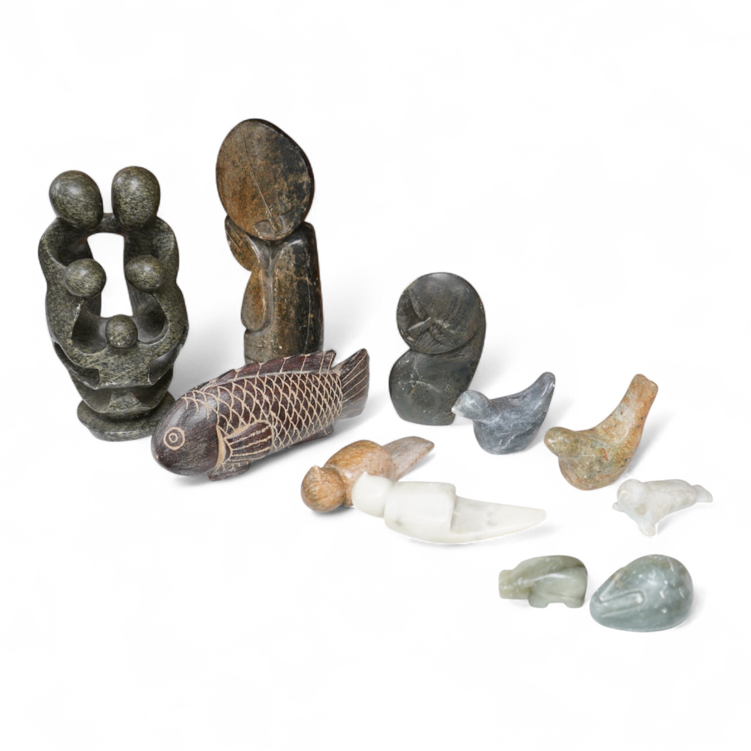 Eleven Inuit related stone carvings, unsigned, to include birds and abstract figures, largest 22cm high